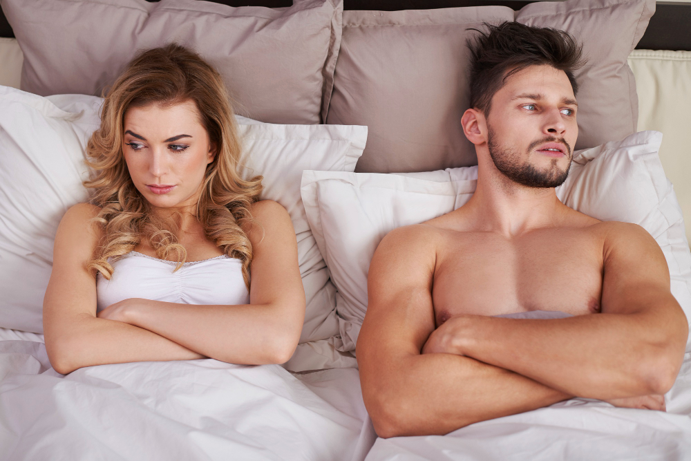 Couple feeling distant in bed